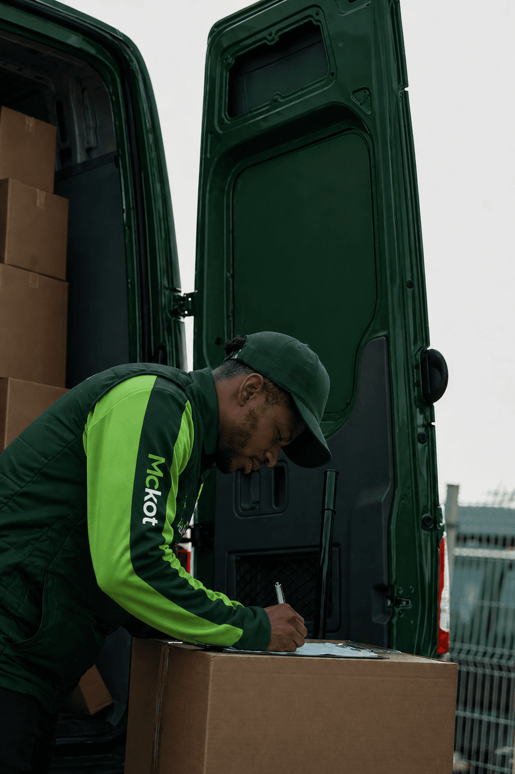 Mckot courier confirming delivery at the van